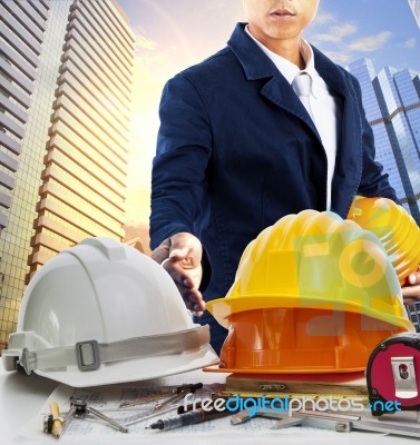 Engineer Man And Working Table Against Sky Scrapper In Urban Scene Use For Land Development And Architecture Occupation Theme Stock Photo