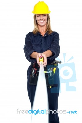 Engineer Woman Stretching Measuring Tape Stock Photo