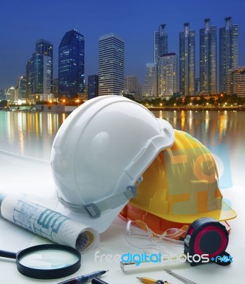 Engineer Working Table With Safety Helmet And Writing Equipment Stock Photo