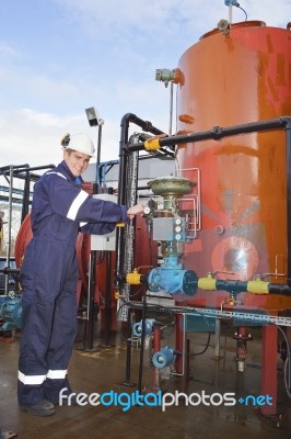 Engineer Working With Oil Refinery Stock Photo