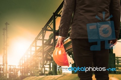 Engineering Man And Safety Helmet Standing Against Beautiful Lig… Stock Photo