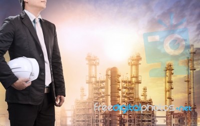 Engineering Man With Safety Helmet Standing Against Oil Refinery… Stock Photo Engineering Man With Safety Helmet Standing Against Oil Refinery… Stock Photo