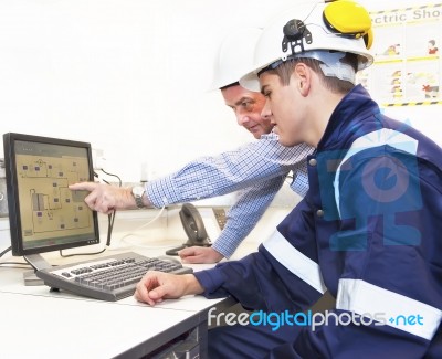 Engineers Discussing In Front Of Pc Stock Photo