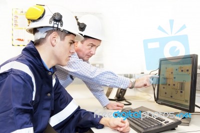 Engineers Discussing In Front Of Pc Stock Photo