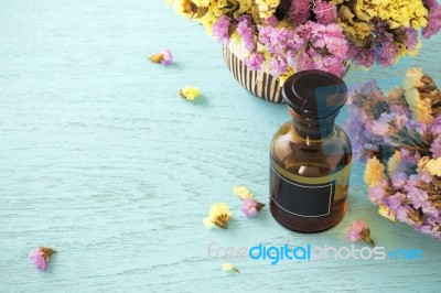 Essential Oil With Flower Background Stock Photo