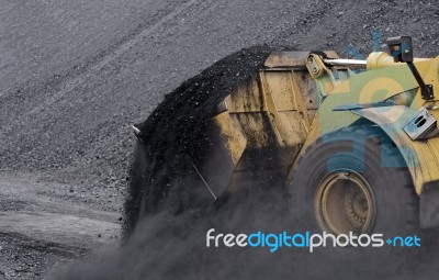 Excavator In Coals Stock Photo