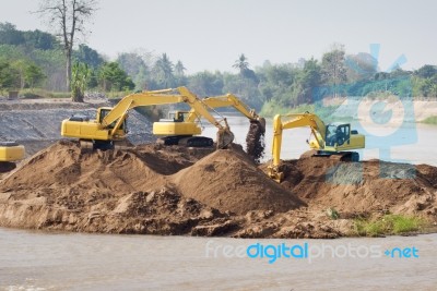 Excavator Machine Group Works At River Stock Photo