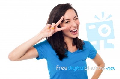 Excited Girl Doing Victory Sign On Eye Stock Photo