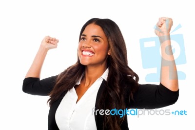 Excited Woman With Arms Raised Stock Photo