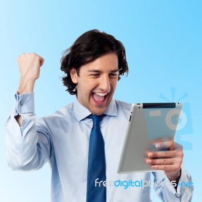 Excited Young Professional With Tablet Pc Stock Photo