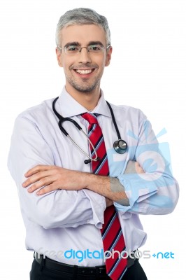 Experienced Doctor With Arms Crossed Stock Photo