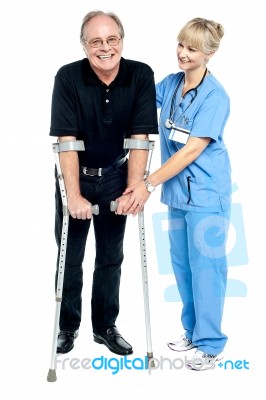 Experienced Physician Assisting Her Patient In Recovery Process Stock Photo