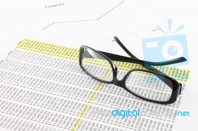 Eye Glasses On Financial Report Stock Photo