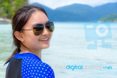 Face Of A Woman Is Smiling At The Camera On The Sea Background Stock Photo