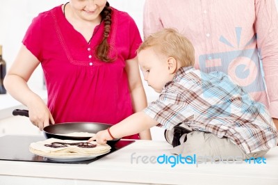 Family Makes Pancakes In The Kitchen Stock Photo