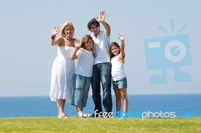 Family of four waving handing Stock Photo