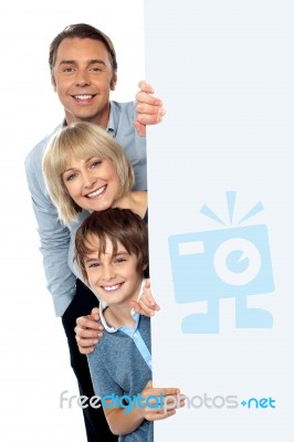 Family Of Three Behind Blank Whiteboard Stock Photo