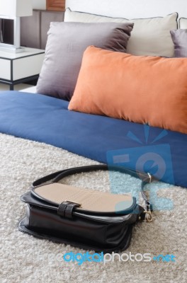 Fashion Female's Bag In Modern Bedroom With Colorful Pillows On Stock Photo