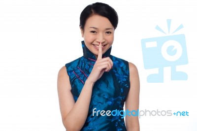Fashionable Woman Putting A Finger On Her Lips Stock Photo