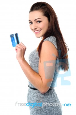 Fashionable Young Girl Holding Up A Credit Card Stock Photo