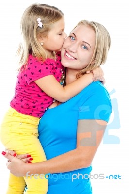 Fashionable Young Kid Kissing Her Mother Stock Photo