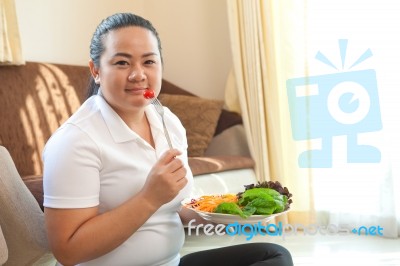 Fat Woman Eating Salad Stock Photo
