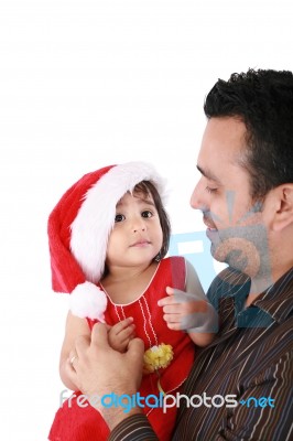 Father And Daughter Looking Happy Wearing Santa Christmas Hat Stock Photo