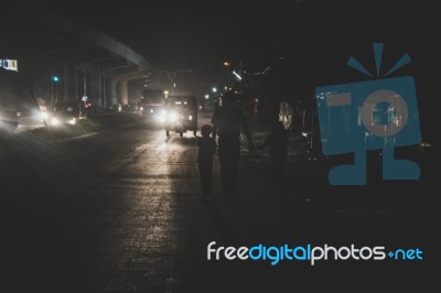 Father Walking With His Two Kids At Night In The City Stock Photo