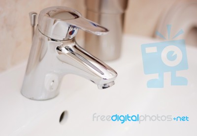 Faucet In A White Sink Stock Photo