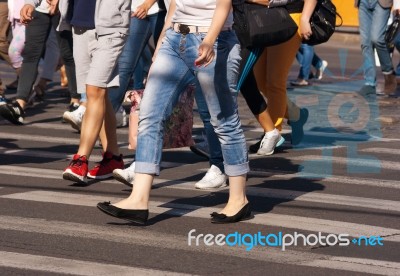 Feet Of Pedestrians Walking On The Crosswalk Stock Photo