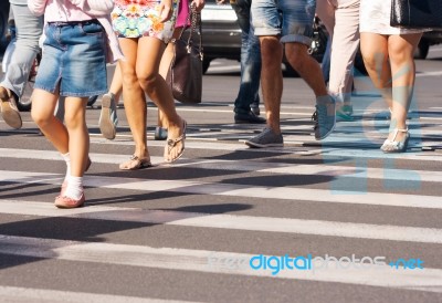 Feet Of The Pedestrians Crossing On City Street Stock Photo