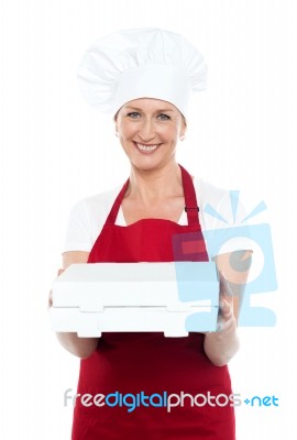 Female Baker Presenting Box Stock Photo