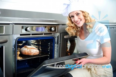 female Baker With Oven Stock Photo