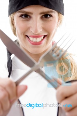 Female Chef Holding Fork And Knief Stock Photo