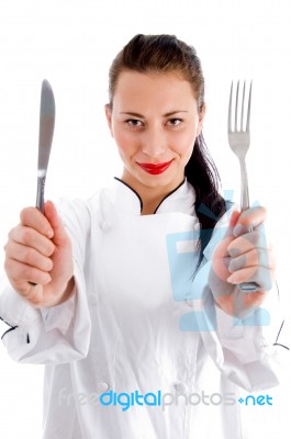 Female Chef holding Fork And Knife Stock Photo