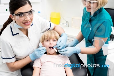 Female Dentist Examine Child Patient Stock Photo