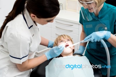 Female Dentist Treat Child Patient Stock Photo