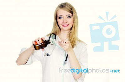 Female Doctor Pouring Syrup Stock Photo