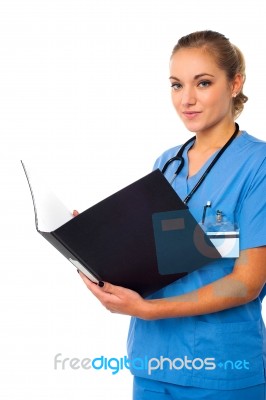 Female Doctor Reviewing Documents Stock Photo