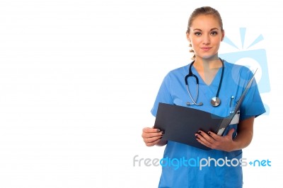 Female Doctor Reviewing Documents Stock Photo
