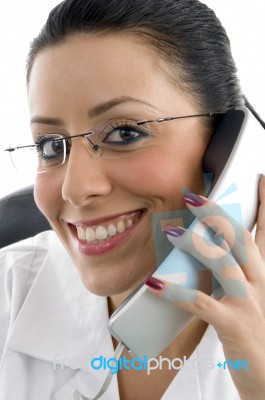 Female Doctor Talking over Phone Stock Photo
