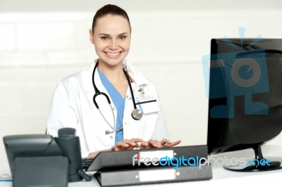 Female Doctor Typing On Keyboard Stock Photo