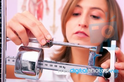 Female Doctor Weighing Stock Photo