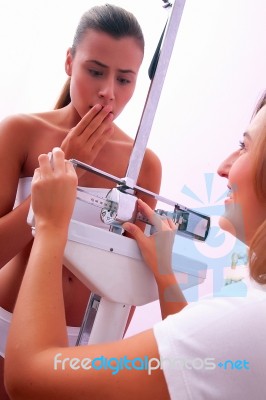 Female Doctor Weighing Patient Stock Photo