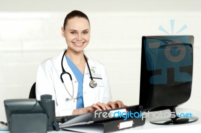Female Doctor Working On Computer Stock Photo