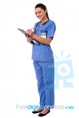 Female Doctor Writing Case History Stock Photo