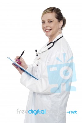 Female Doctor Writing Clipboard Stock Photo