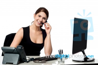 Female Executive Assisting Client Over A Call Stock Photo