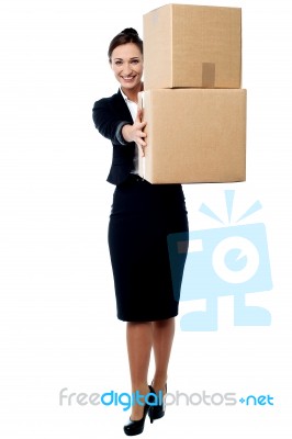 Female Executive Displaying Carton Boxes Stock Photo