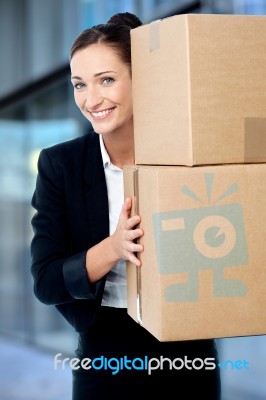Female Executive Holding Cardboard Boxes Stock Photo